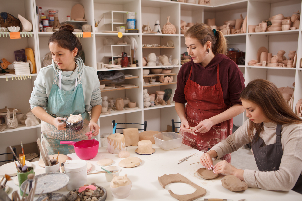 Three women working at ceramics studio