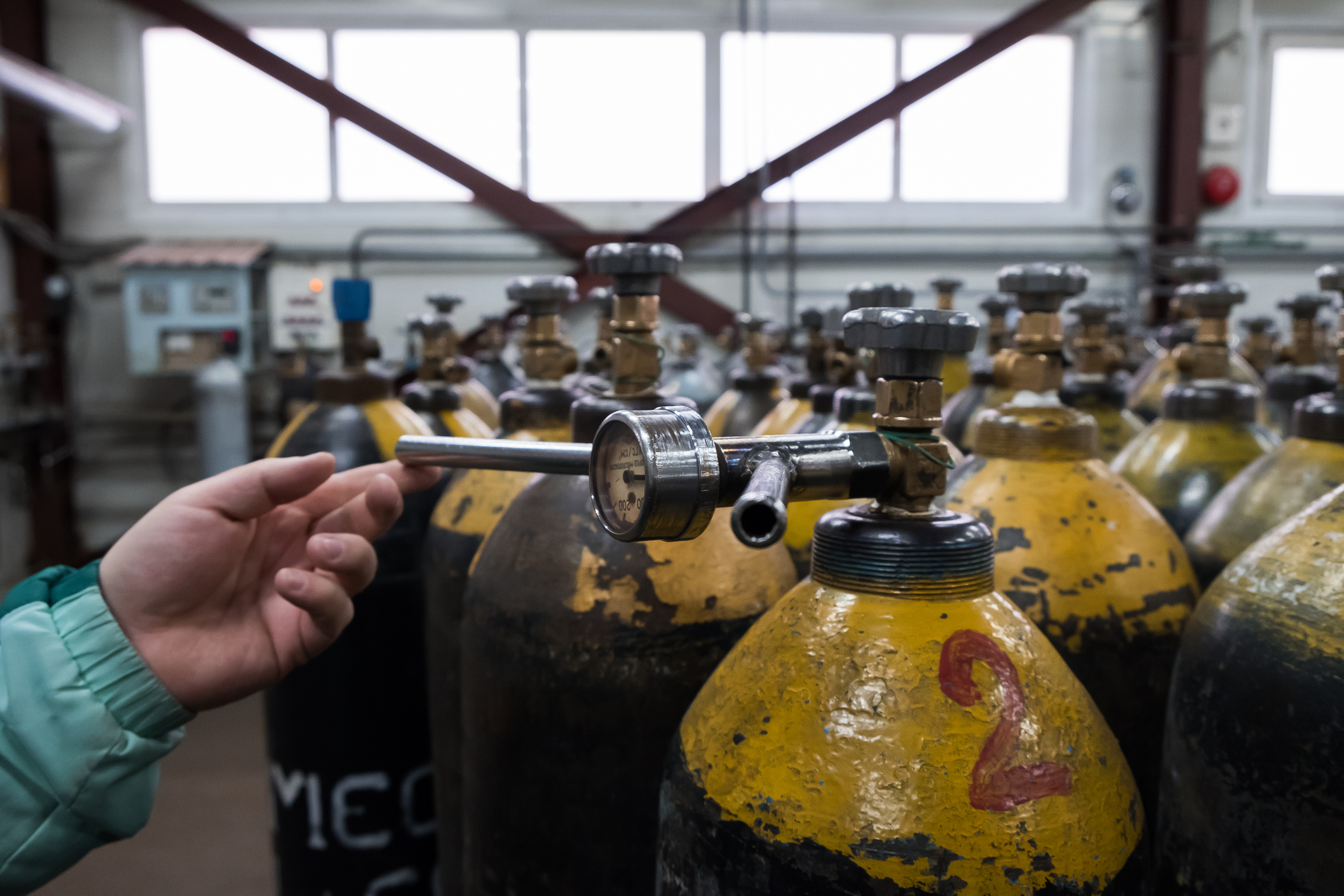 Pressure Tank and Regulator Gauges. Man checking manometer in liquid gas factory.